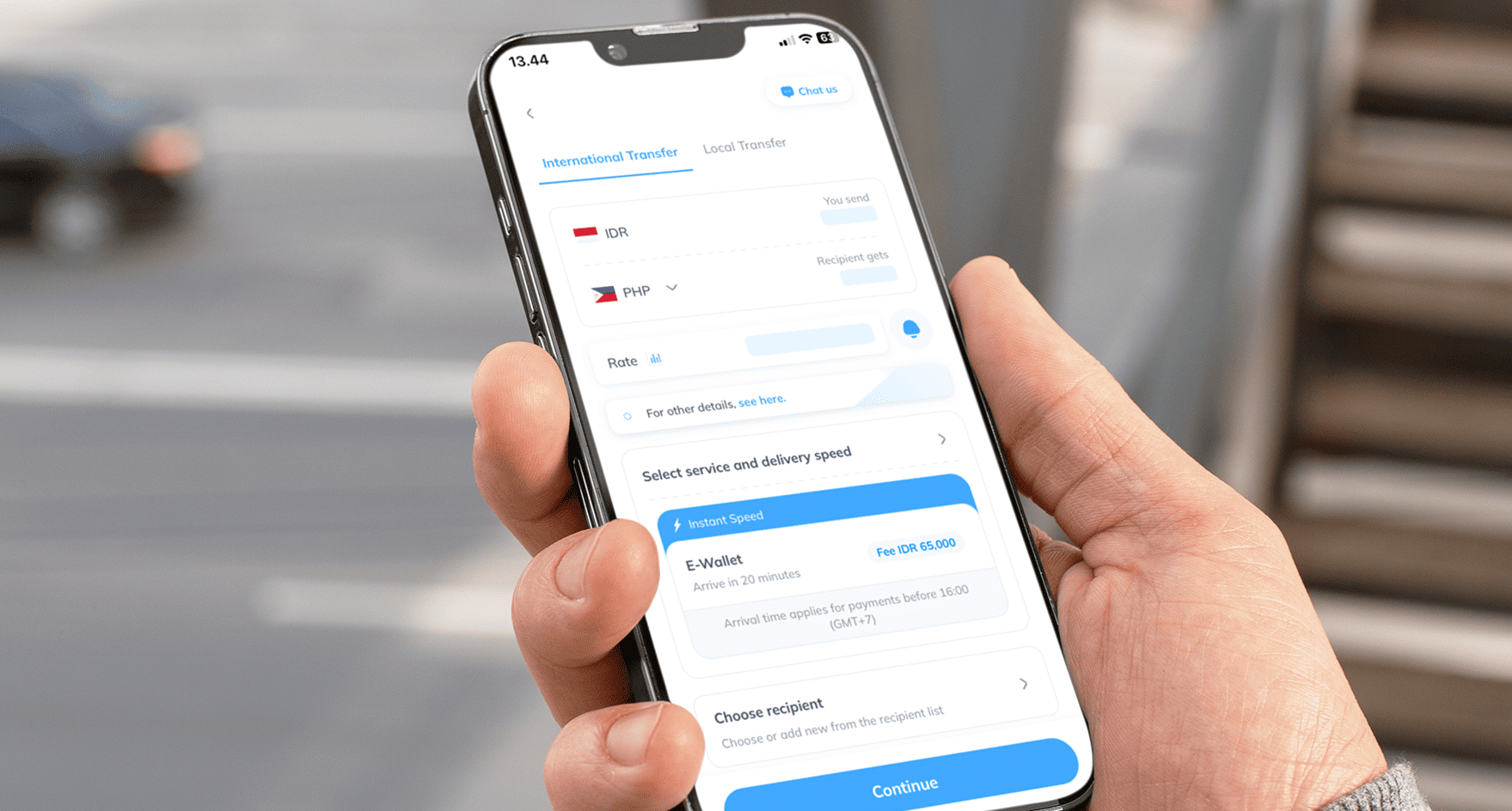Phone in hand showing transfer to Maya Wallet via Topremit
