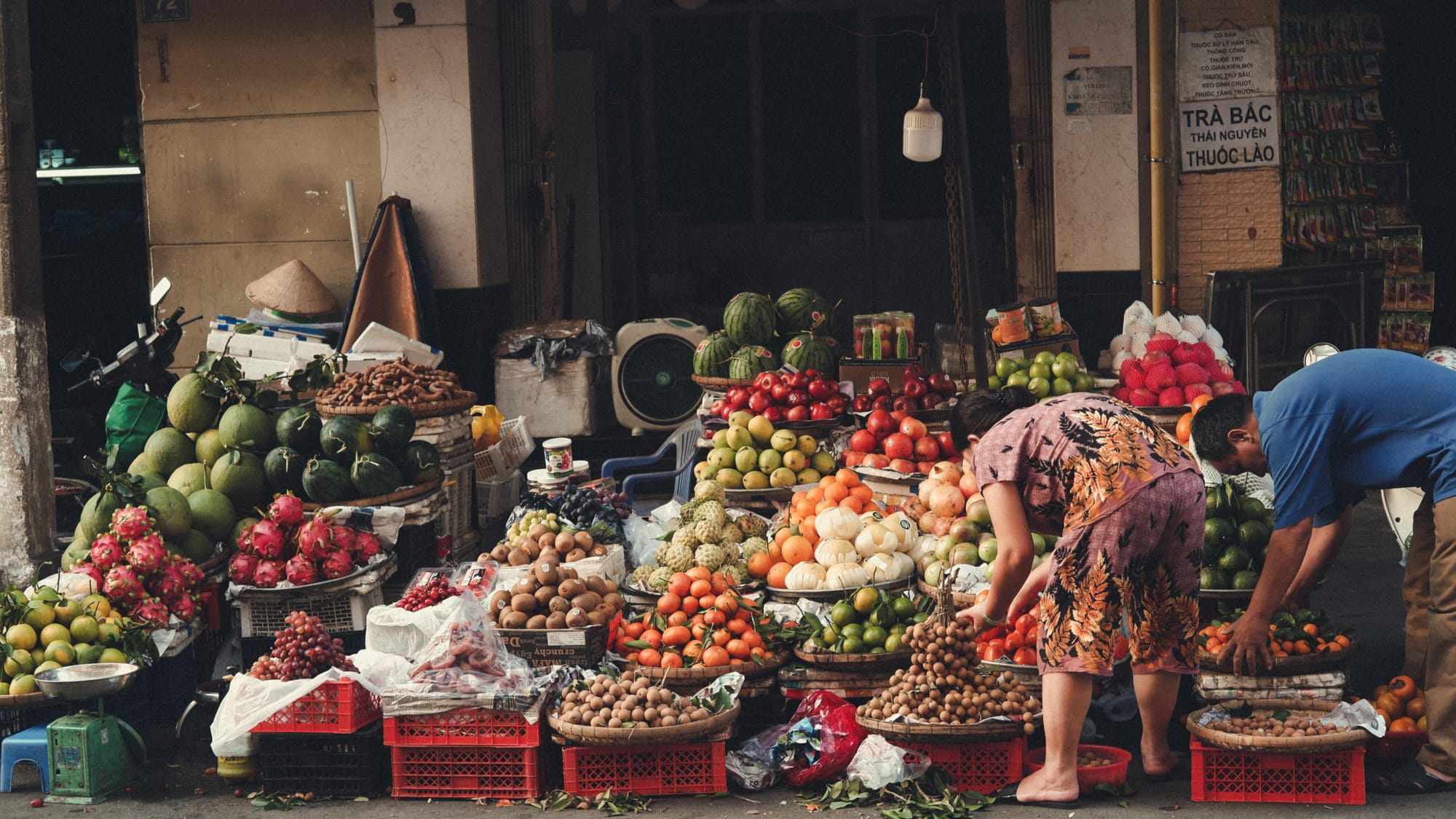 Local vendors selling fresh fruits at a traditional market in Indonesia