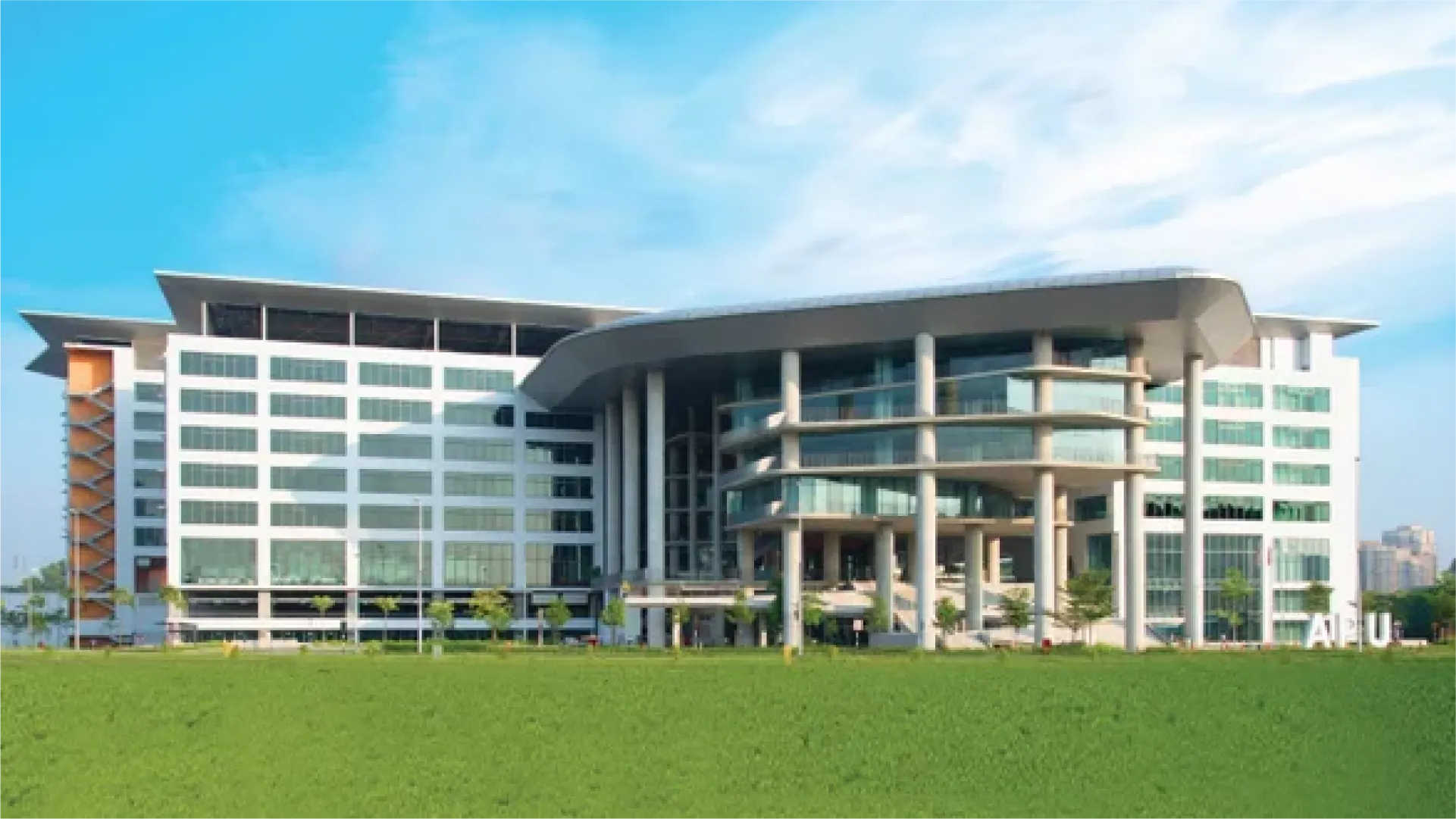 Gedung kampus Universiti Kebangsaan Malaysia dengan area hijau di depannya