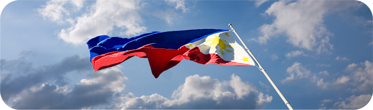 Bendera Filipina berkibar di langit sebagai ilustrasi negara tujuan transfer internasional.