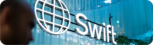 Logo SWIFT (Society for Worldwide Interbank Financial Telecommunication) di sebuah gedung perkantoran modern.